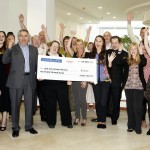 Smiths News PLC staff with £100k cheque for charities